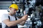 technician doing machine maintenance